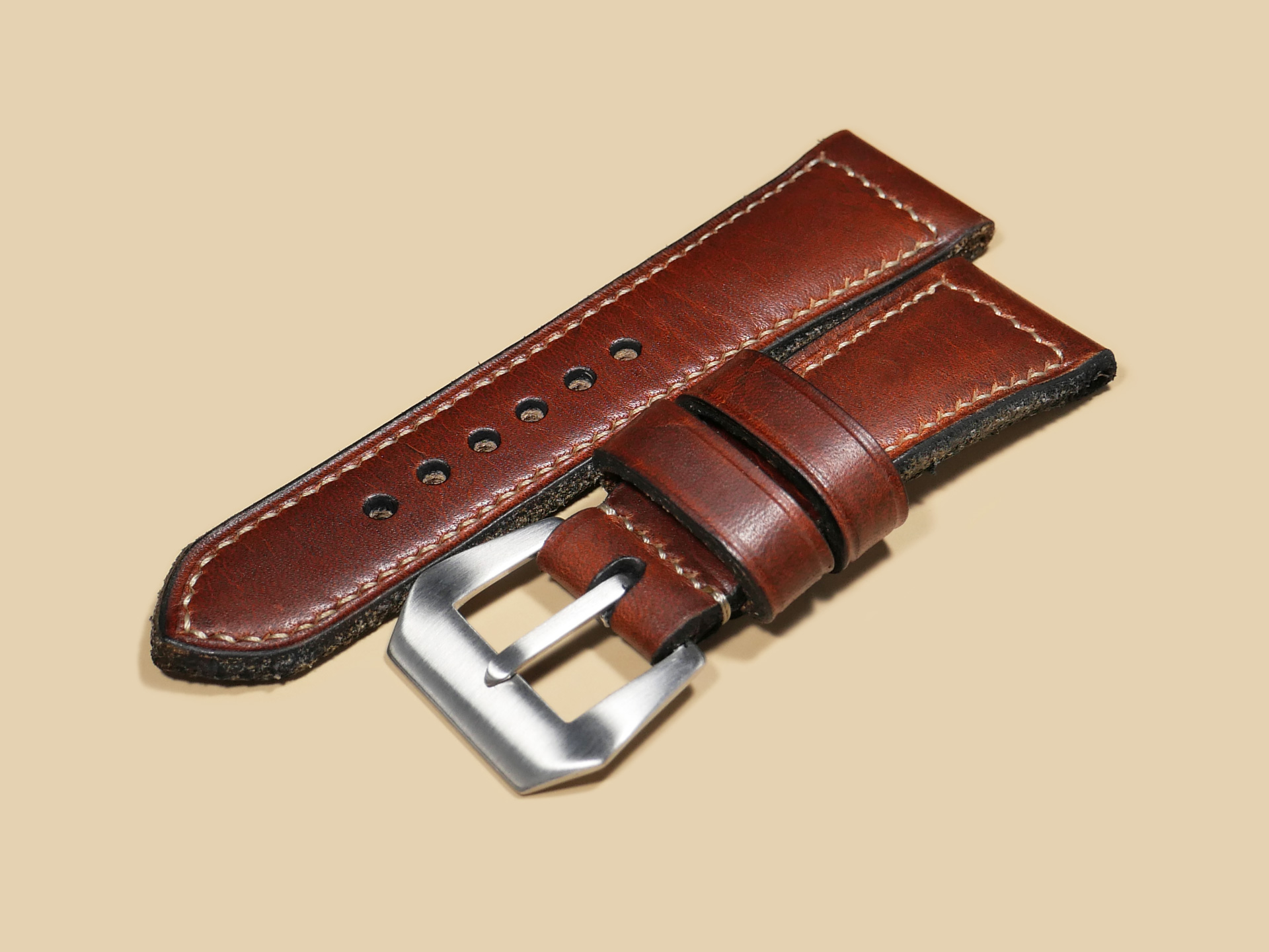 Close-up of chrome-tanned leather with polished mahogany luster