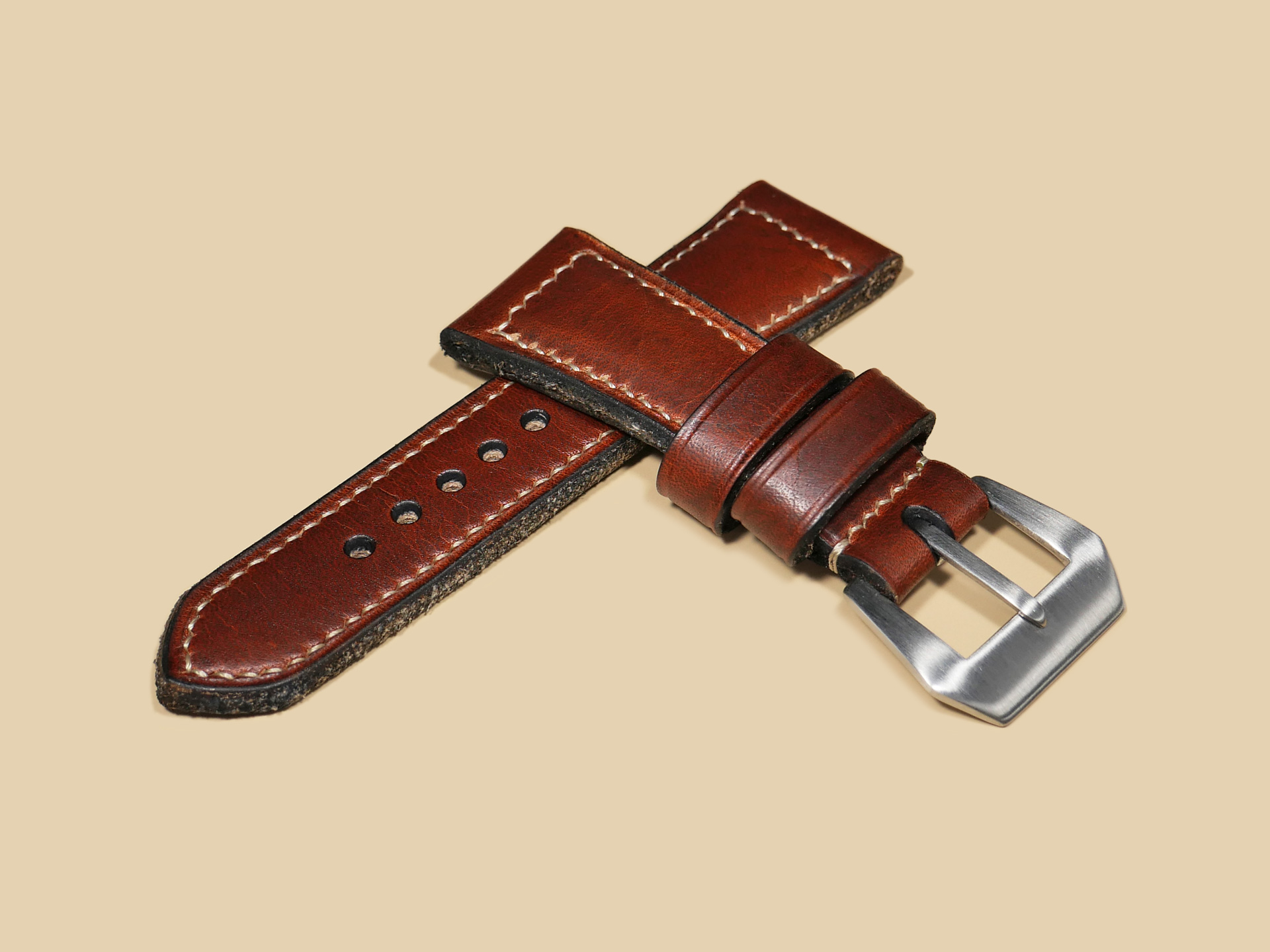 Six-piece custom-cut Radiomir strap laid out before assembly