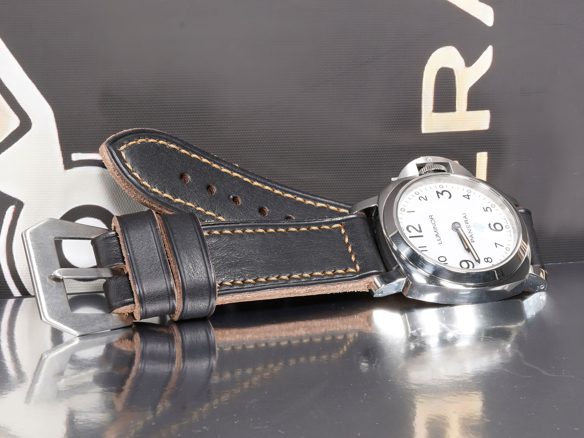 Close-up of Thick Black Panerai Strap 44mm Handmade mounted on Luminor case under studio lightin