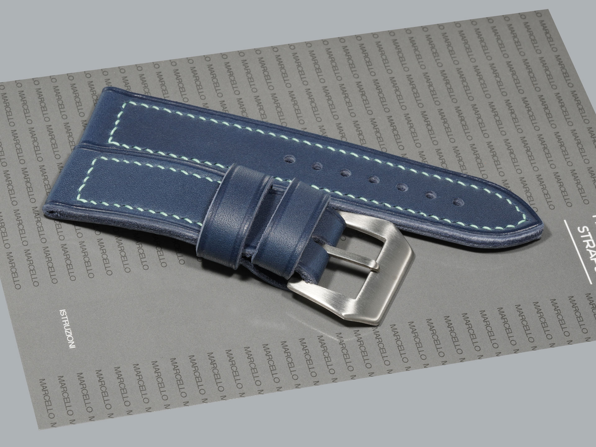 Blue Panerai strap laid flat with floating and fixed keepers visible