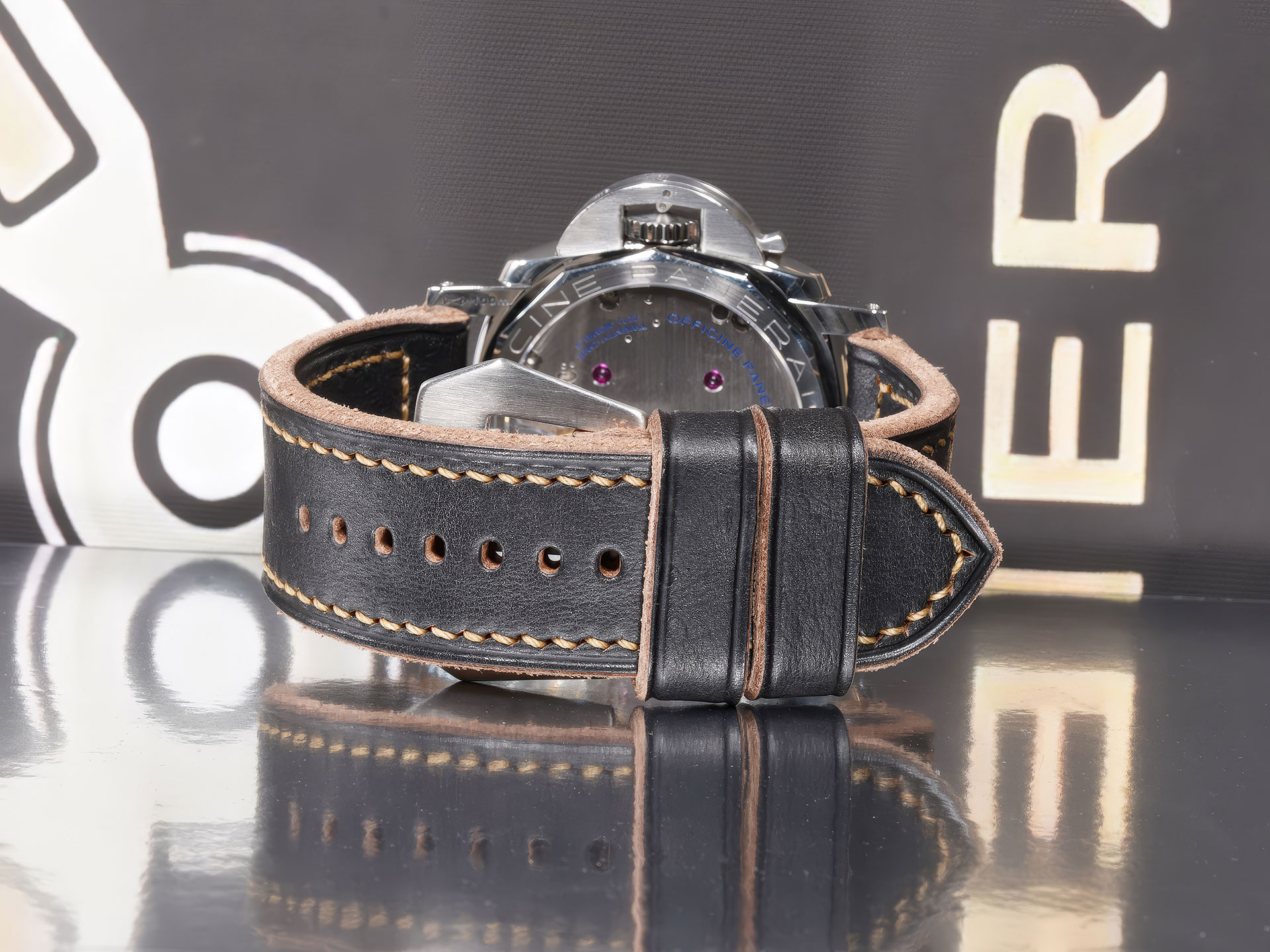 Overhead flat-lay of Thick Black Panerai Strap 47mm Handmade beside brushed flat vintage buckle