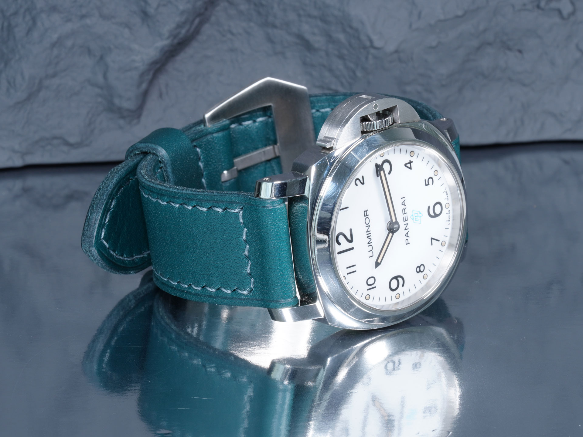 Green leather Luminor strap with pin buckle, angled to show taper and texture