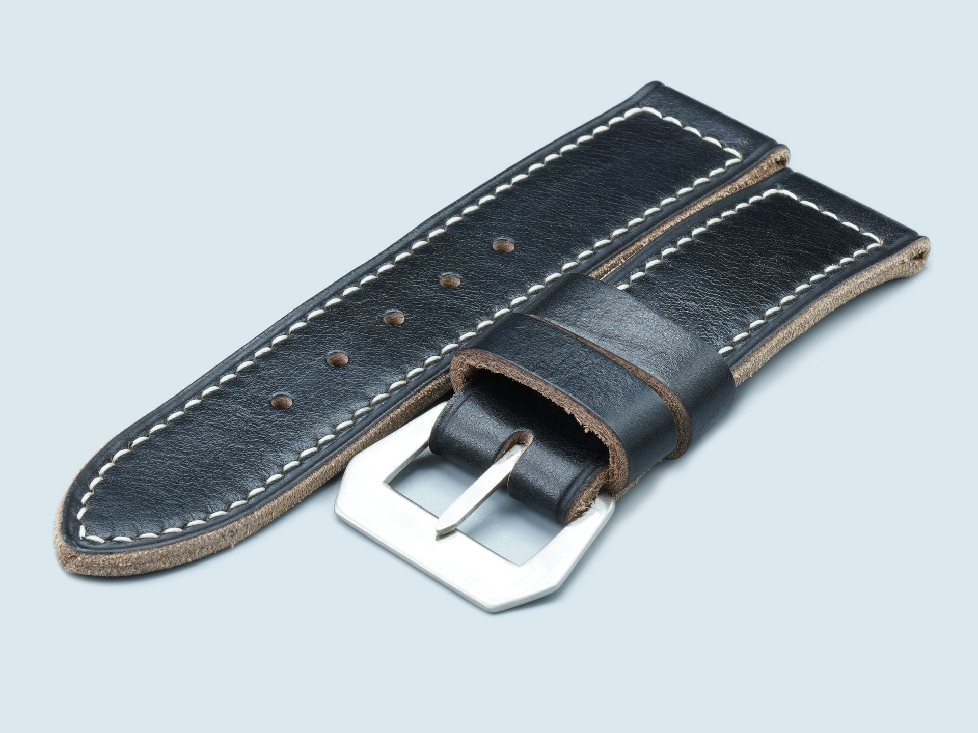 Thick 4mm black leather strap with hand-stitched wax thread detail.