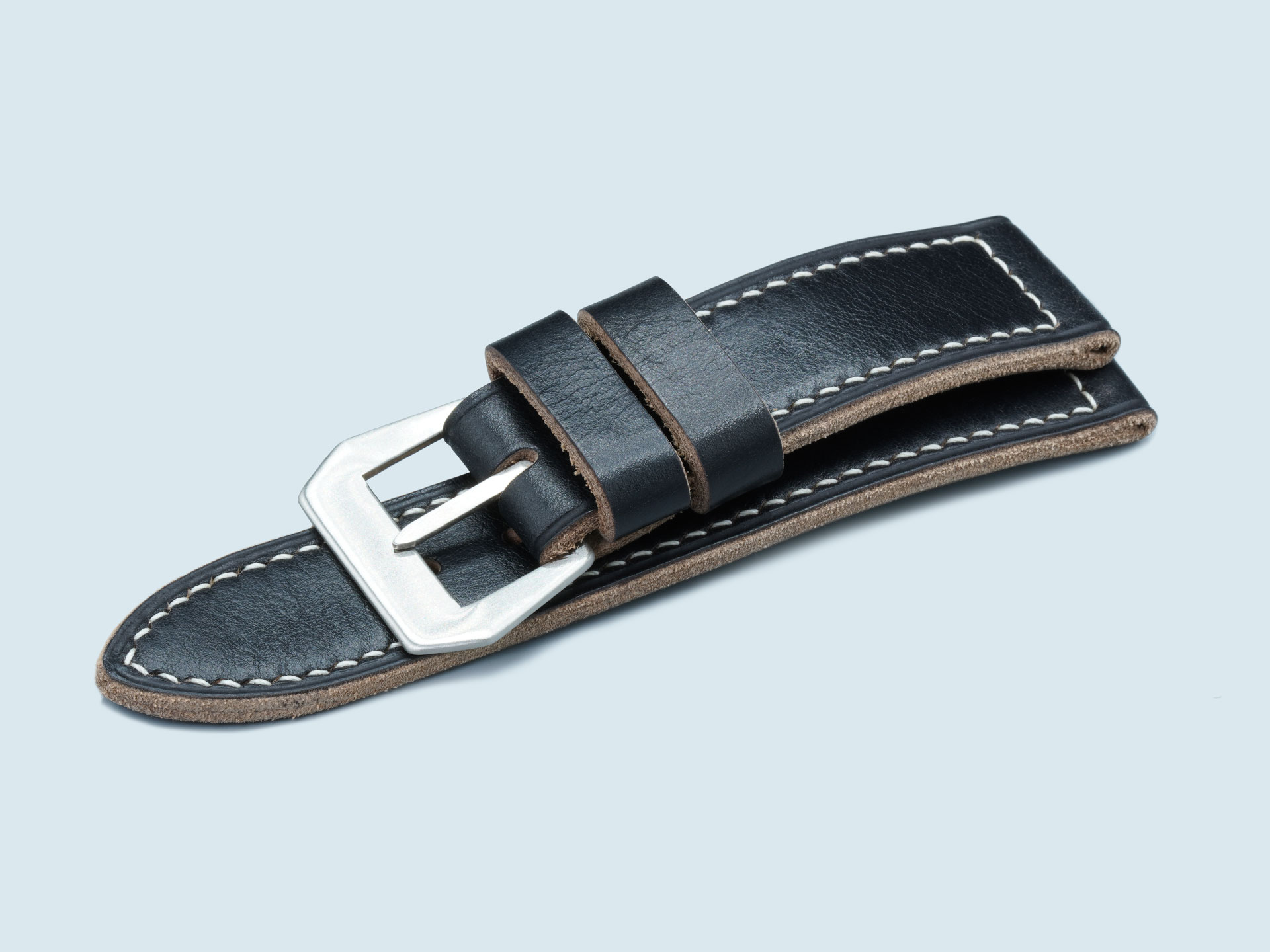 Hand-burnished edges on a 47mm black vintage-style watch band.