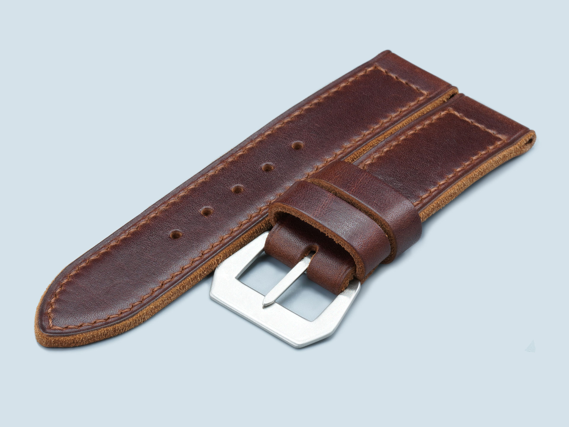 Brown stitching detail on semi-gloss leather watch strap.