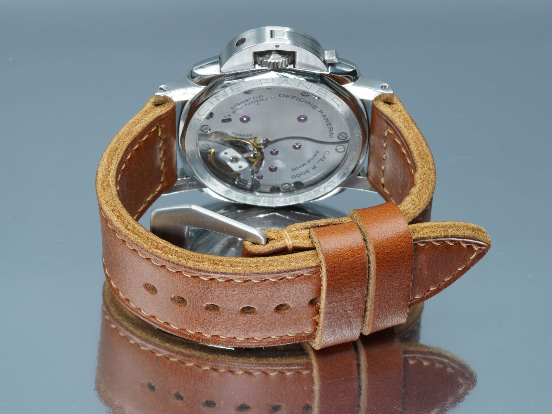 Tan leather Panerai strap, handcrafted with a vintage flat buckle, wrist-shot view