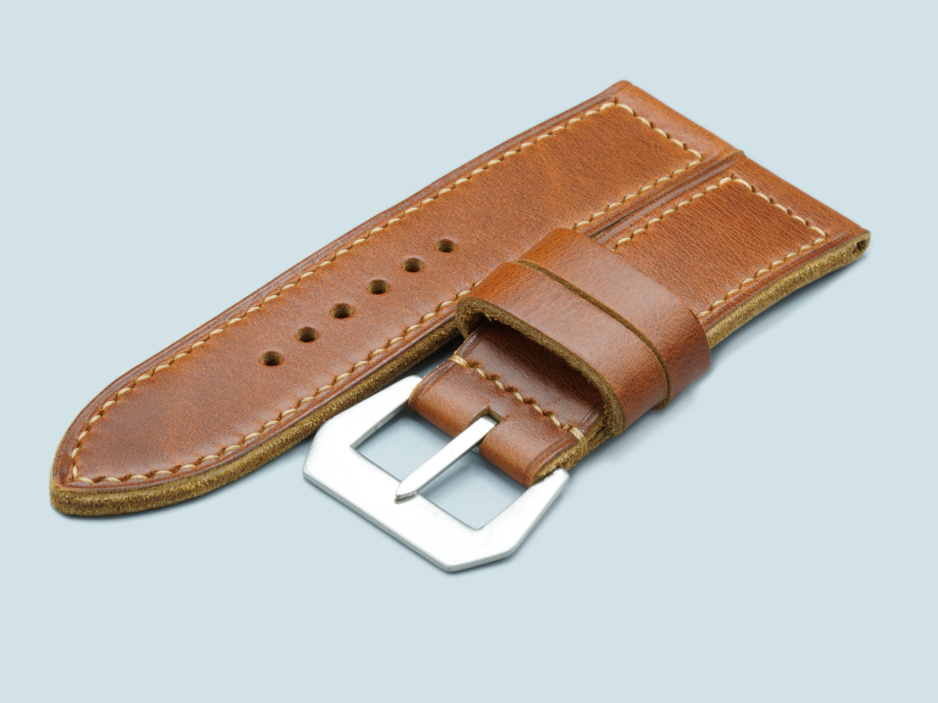Close-up of the vintage flat buckle on a tan leather Panerai strap for 47mm watches