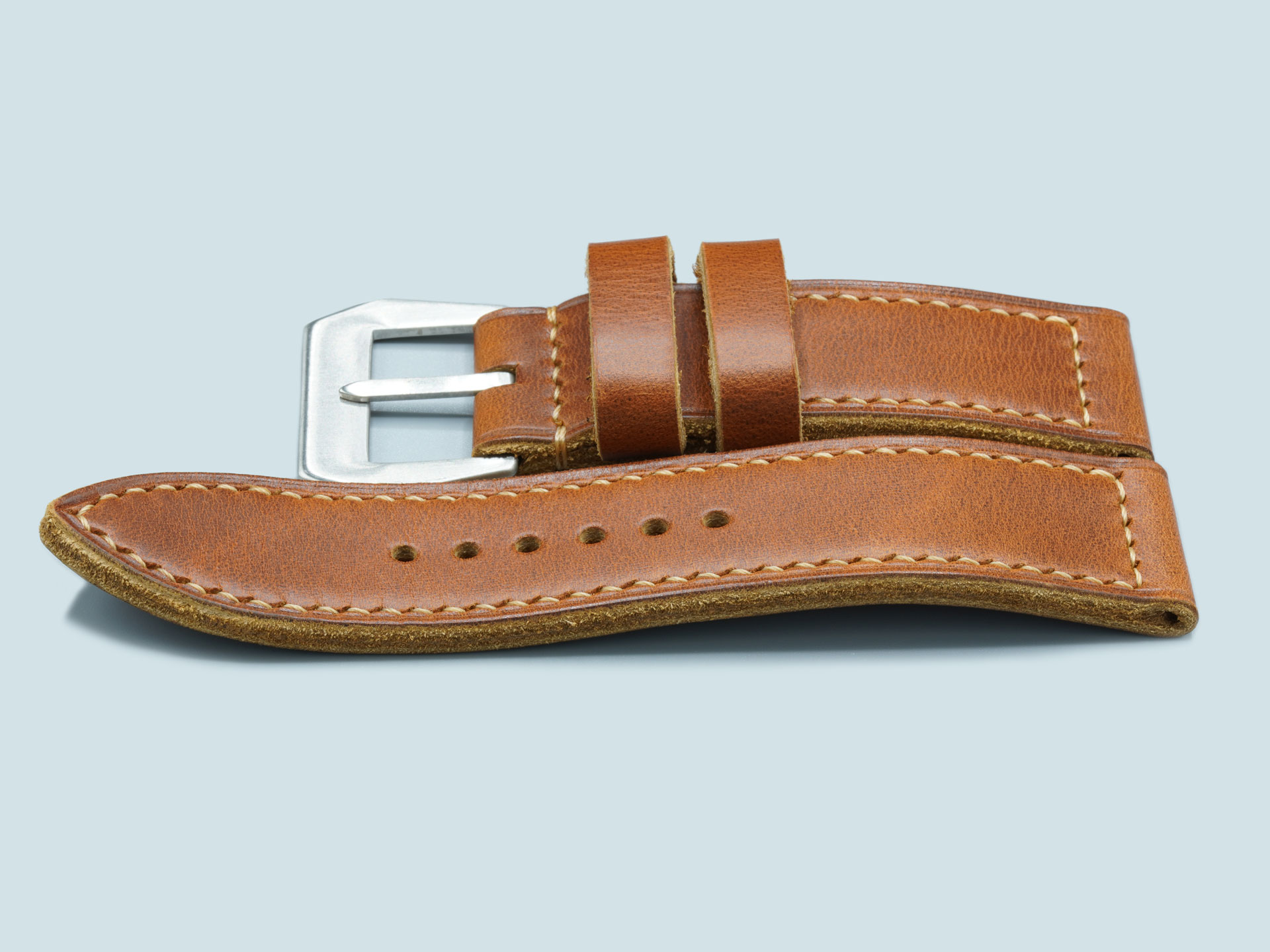 Side profile of a handcrafted tan leather strap for 47mm Panerai watches with vintage flat buckle