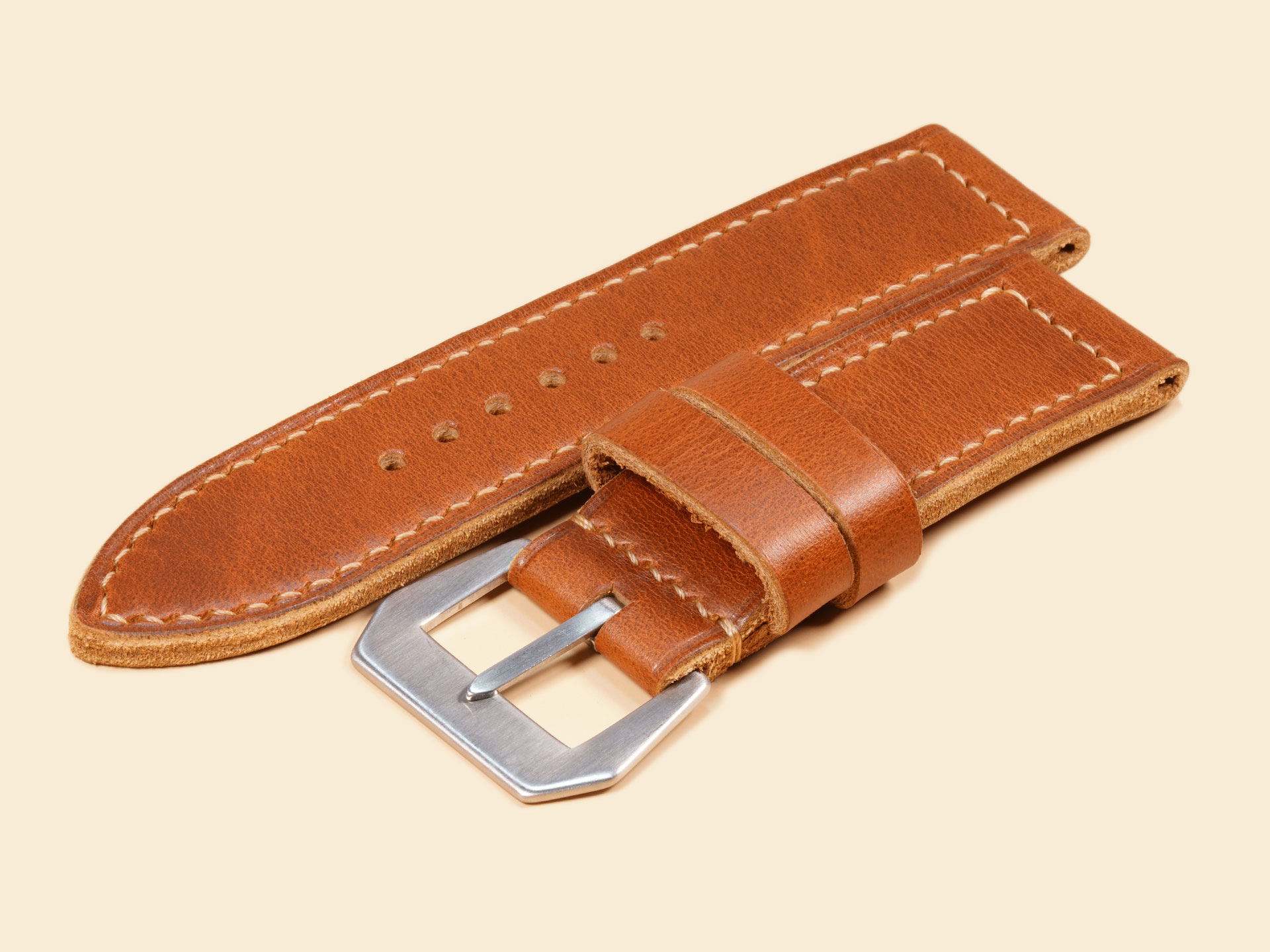 Distressed tan leather watch strap featuring high-contrast cream boxed stitching for Panerai.