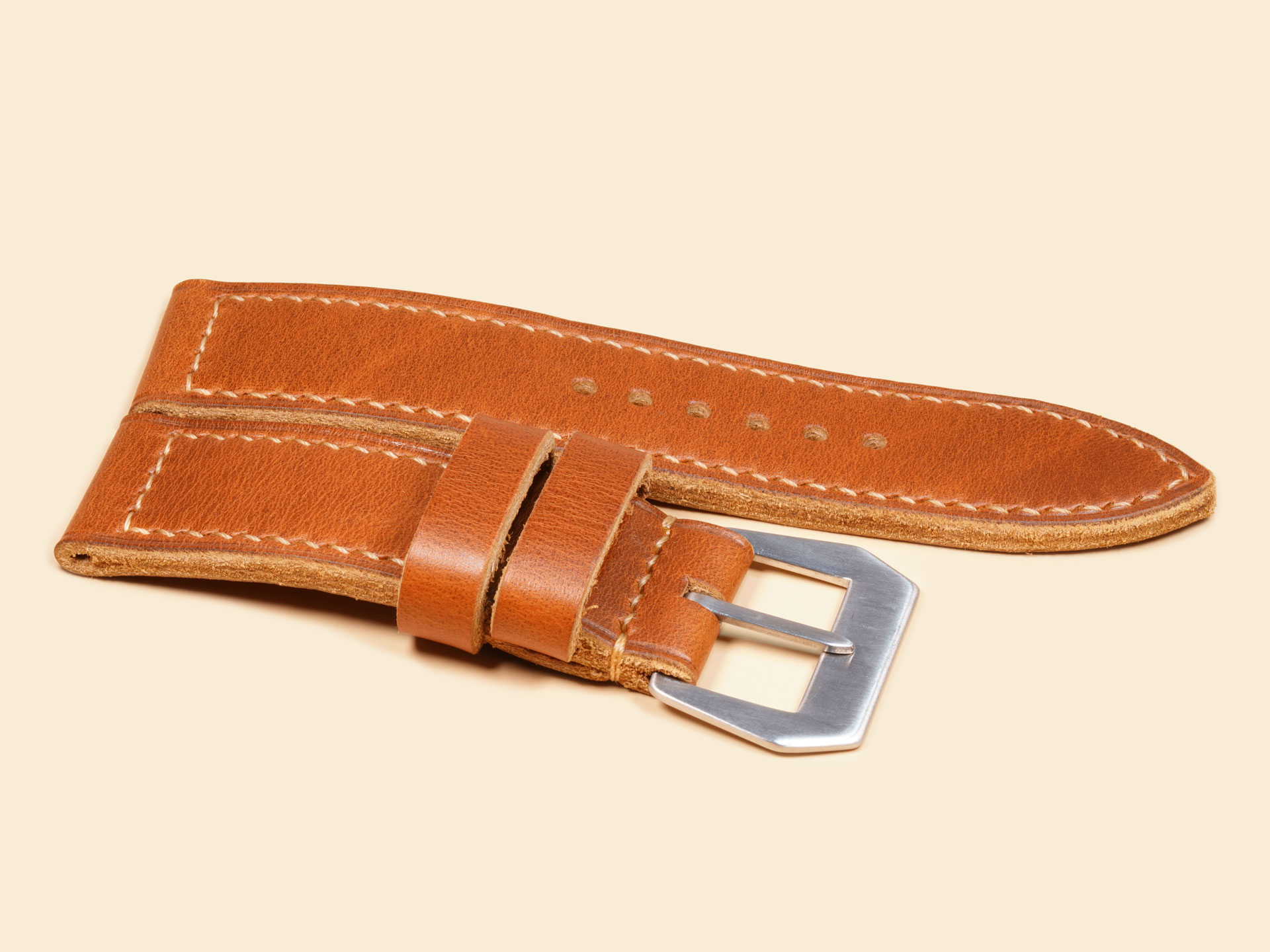 Handcrafted tan leather strap highlighting a subtle creased edge detail for Panerai Luminor.