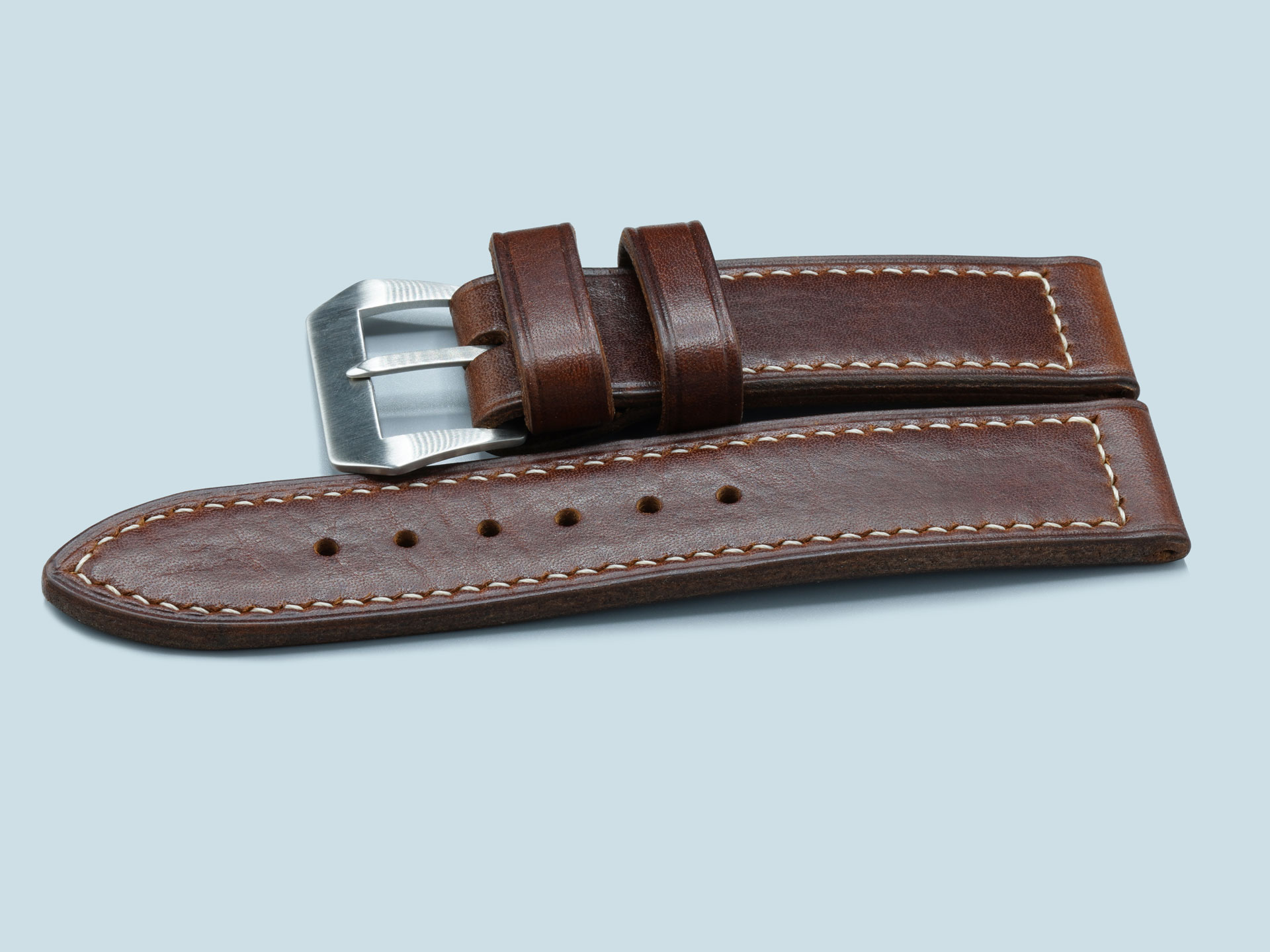 A dark brown, vintage style Panerai strap for 47mm Luminor cases, stitching detail