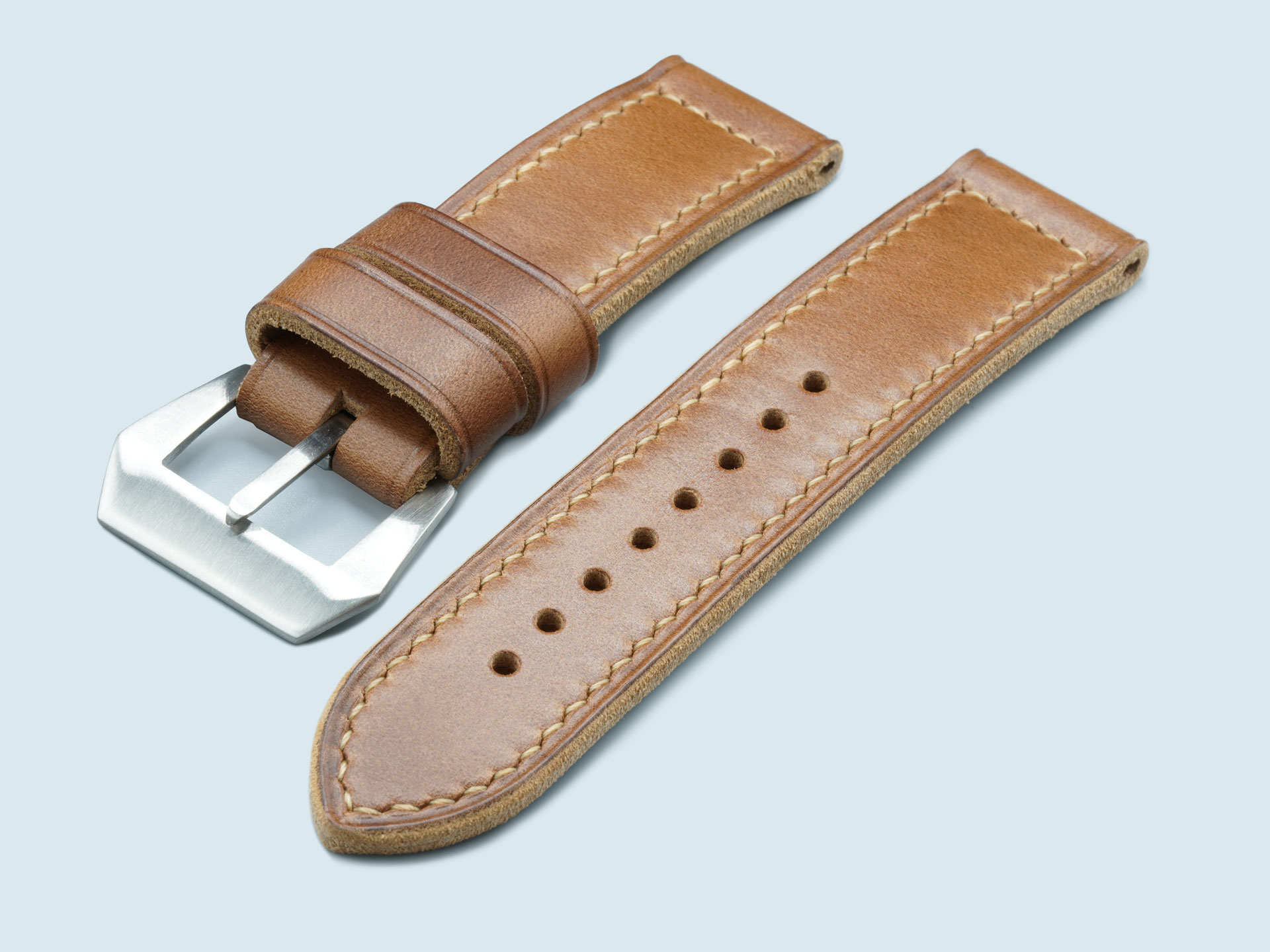 Side profile of a handcrafted caramel brown leather strap for Panerai Luminor 44mm