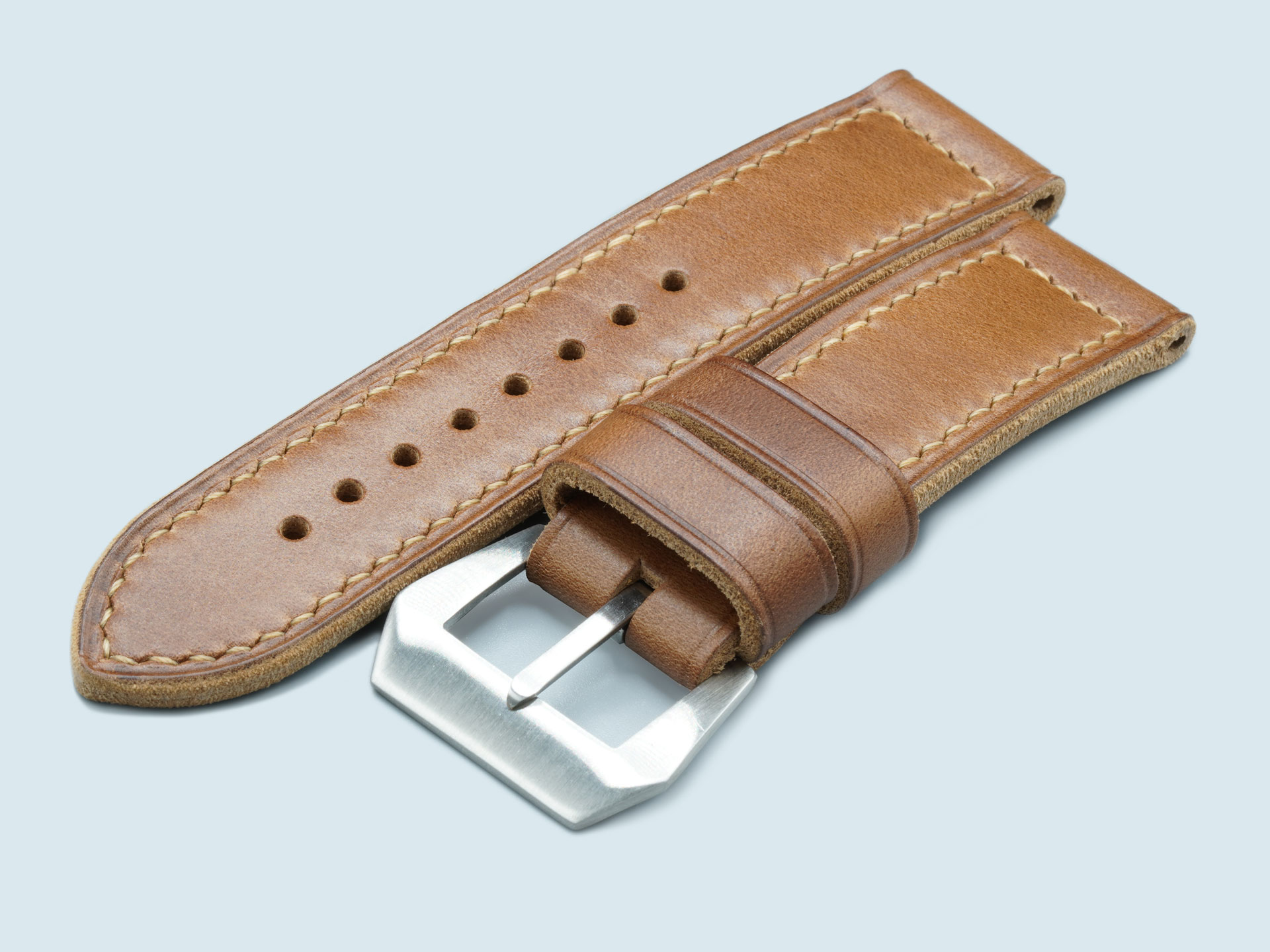Buckle hardware detail on a thick caramel Panerai Luminor strap, handcrafted by Marcello Straps