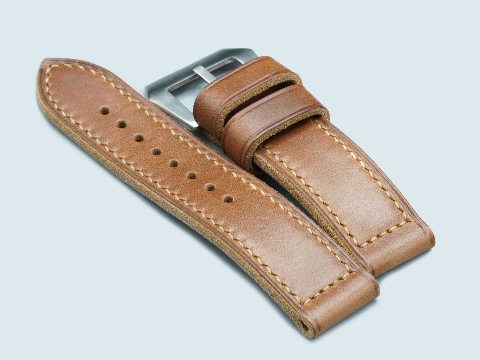 Macro shot of caramel brown leather grain on a thick handcrafted Panerai strap