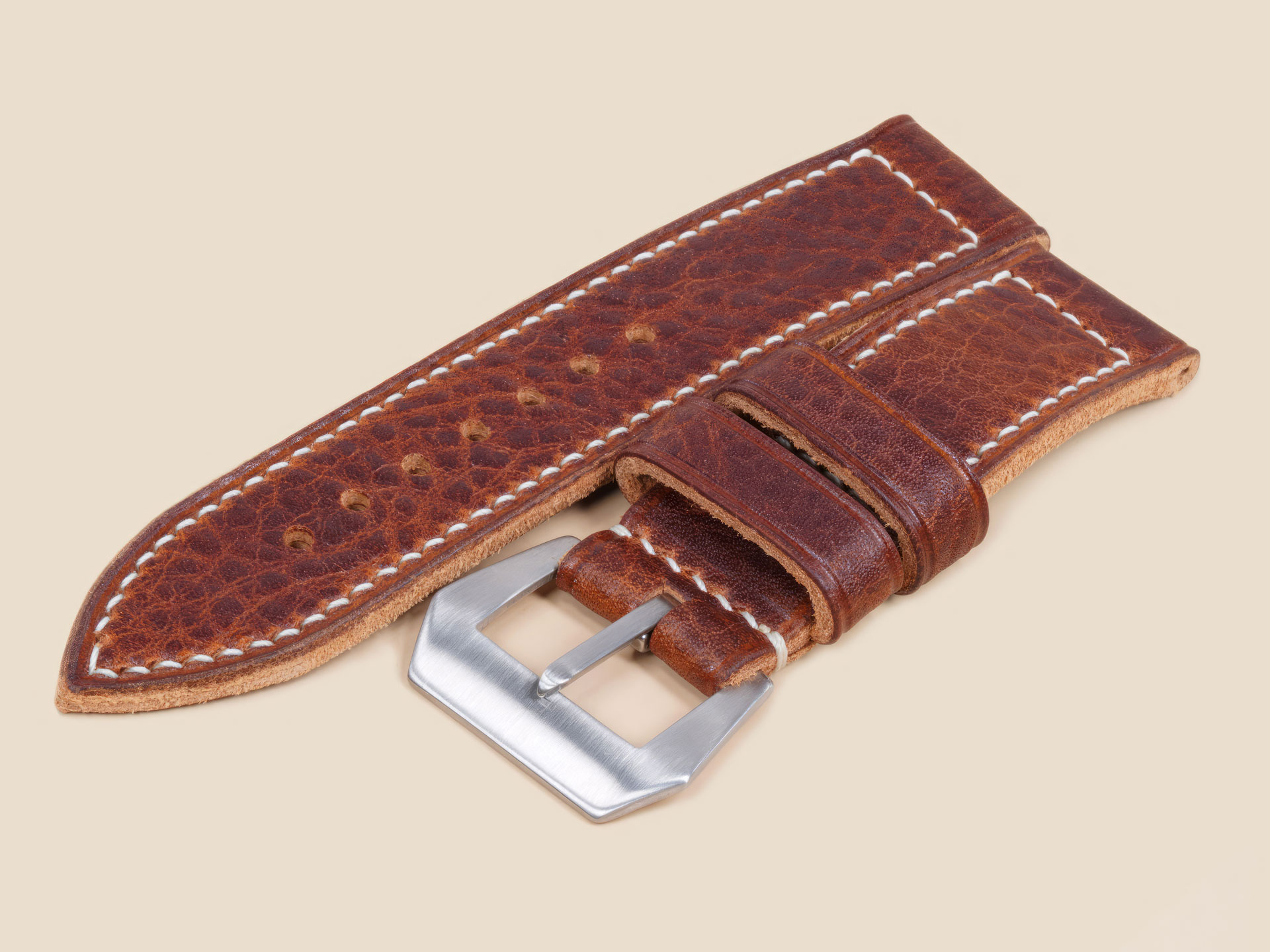 Side profile of a handmade brown Panerai watch strap showing thickness and taper