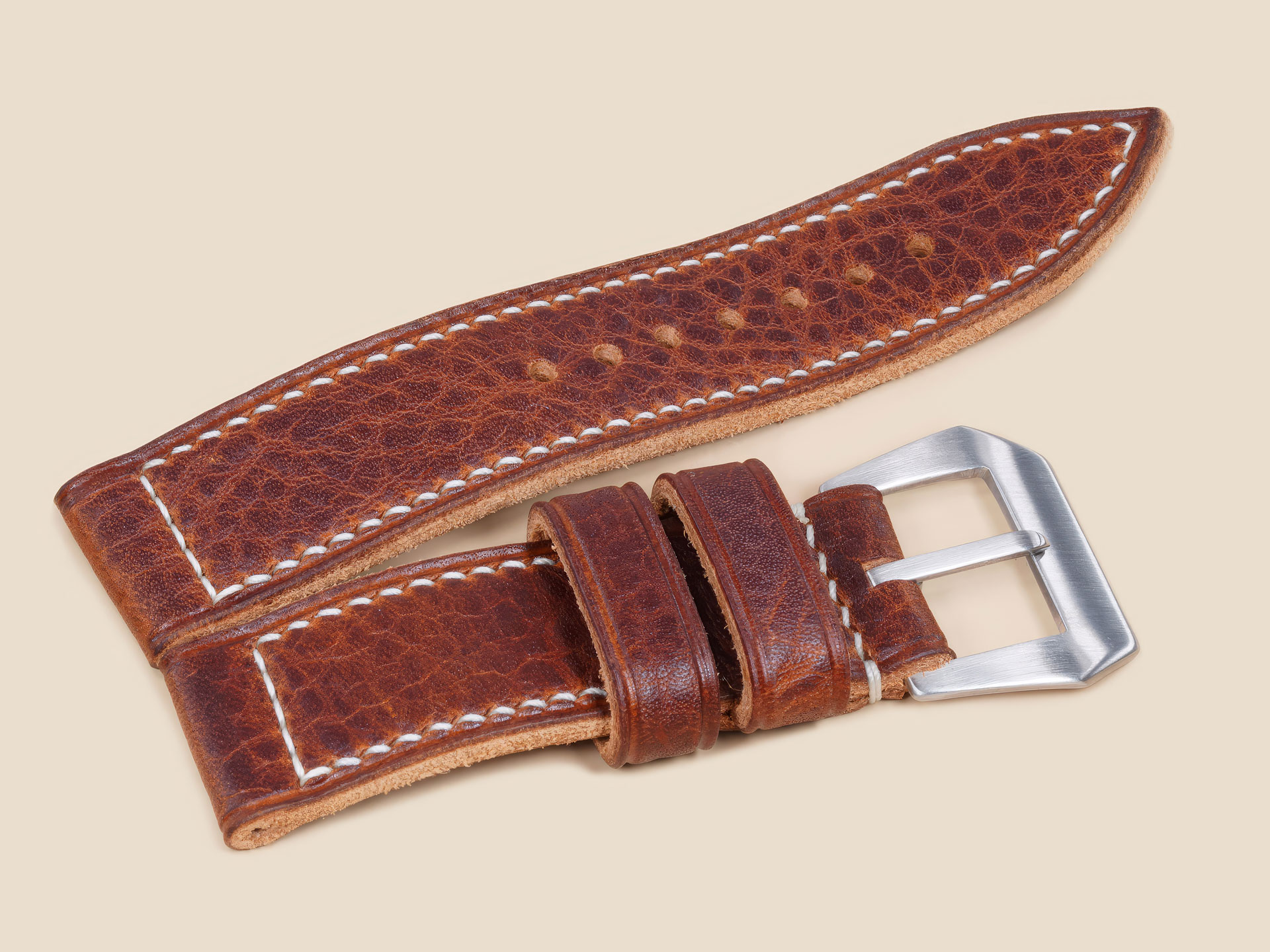Lug end detail on a 44mm Panerai leather strap, textured brown, handmade