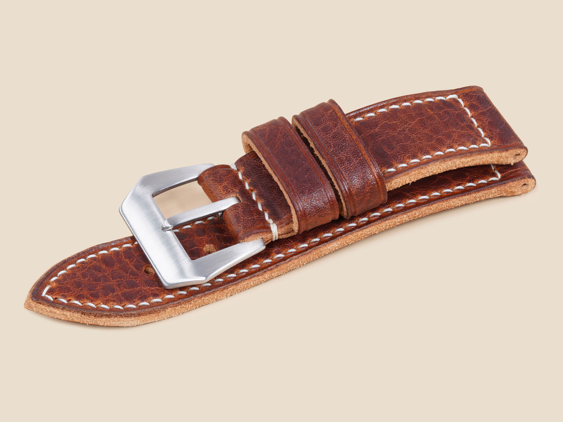 Macro detail of natural grain texture on a handmade brown Panerai strap
