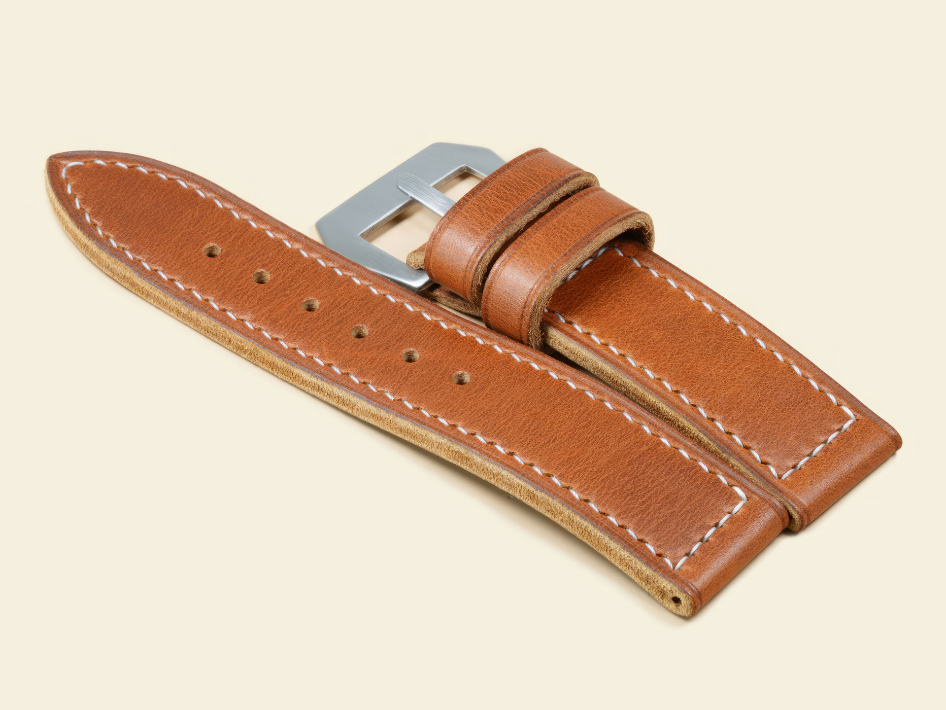 Profile view of a thick tan leather strap for a 47mm Panerai Luminor.