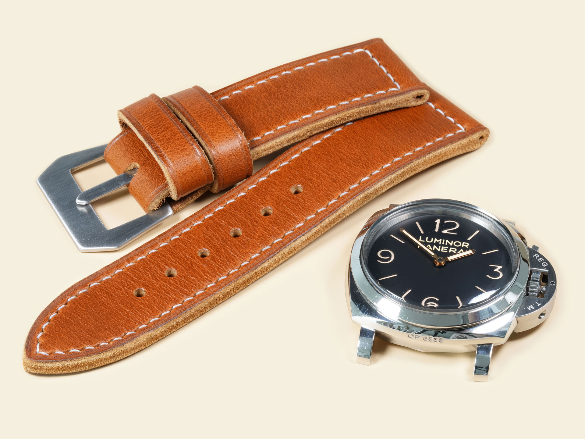 Distressed tan leather strap showing a sewn-in GPF-style buckle for Panerai.