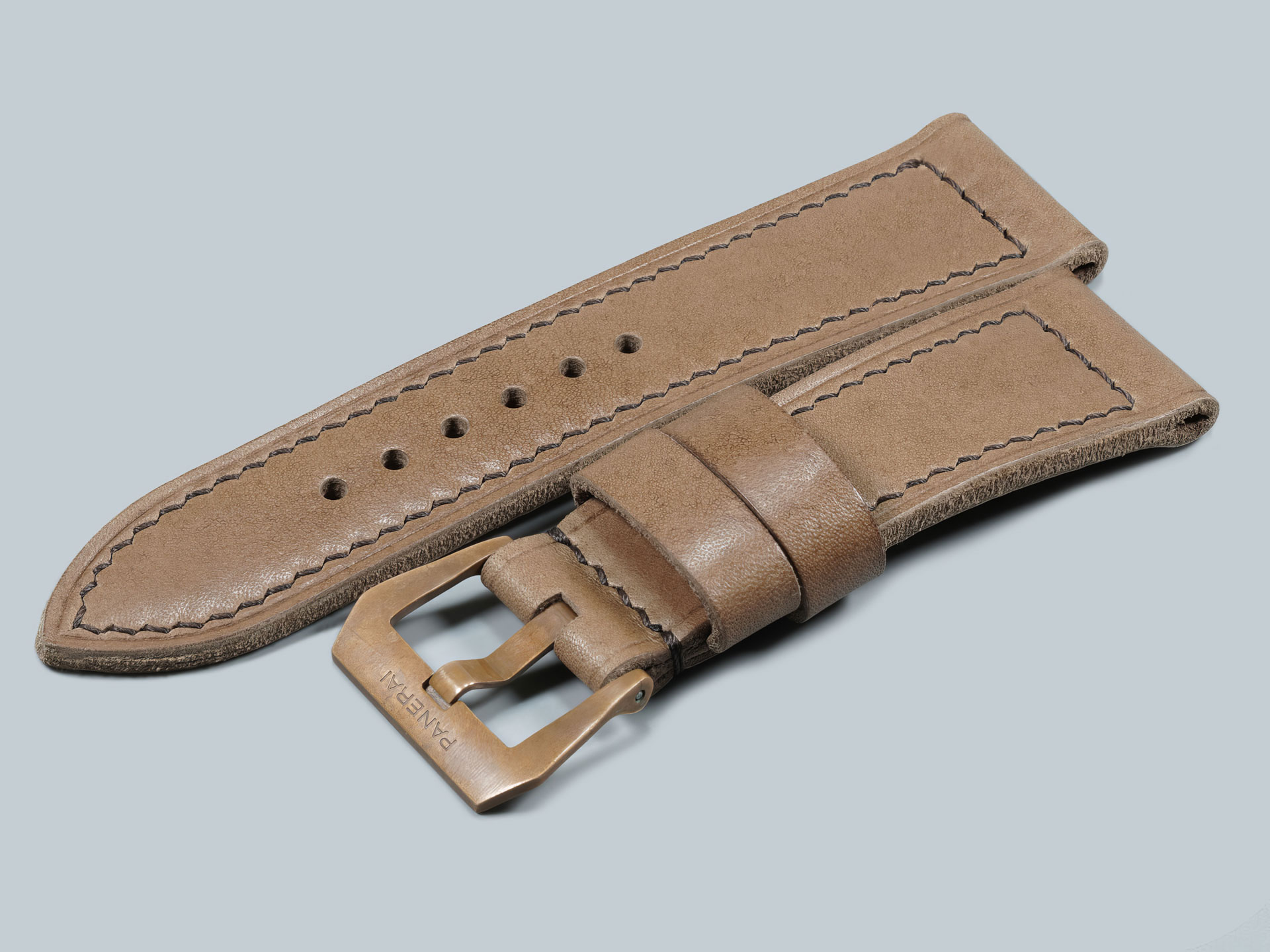 Macro view of brown stitching on a custom Panerai Bronzo strap for PAM00968, handmade.