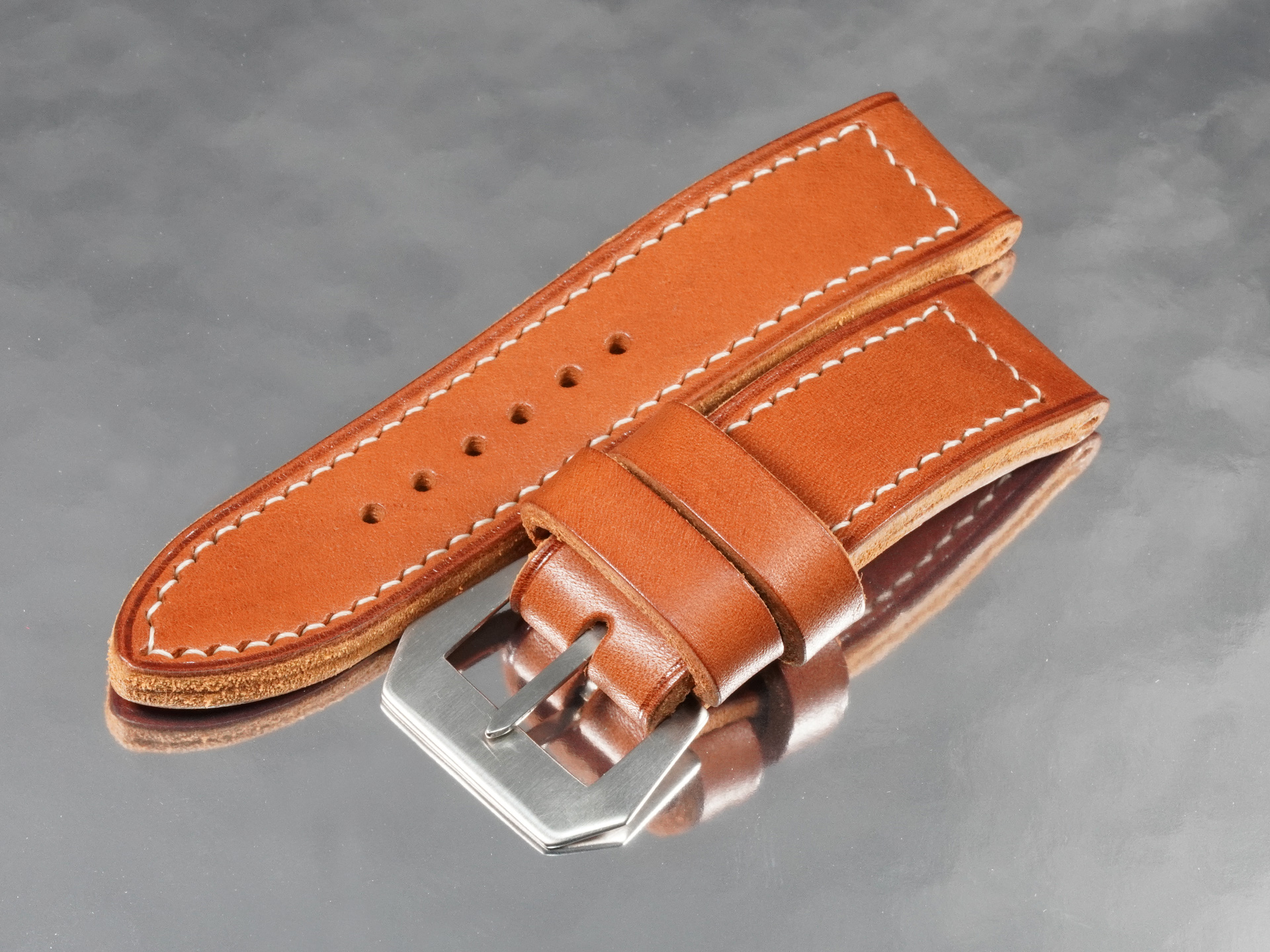 Extreme macro of heavy gauge waxed linen saddle stitching on custom thick Panerai strap