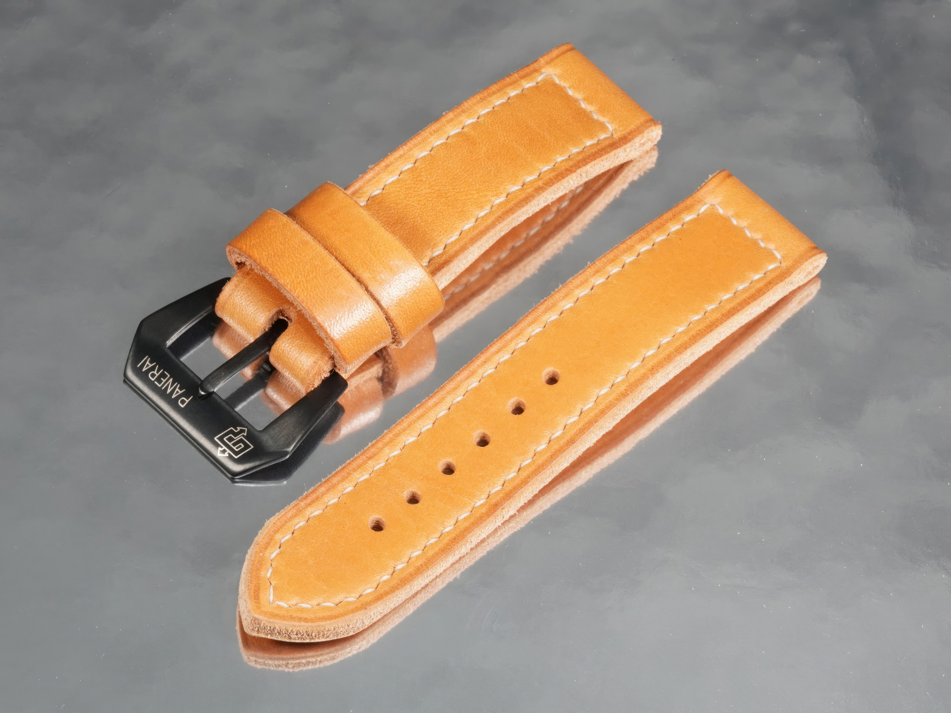 Overhead view of orange tan Panerai PAM01707 leather strap with black PVD buckle