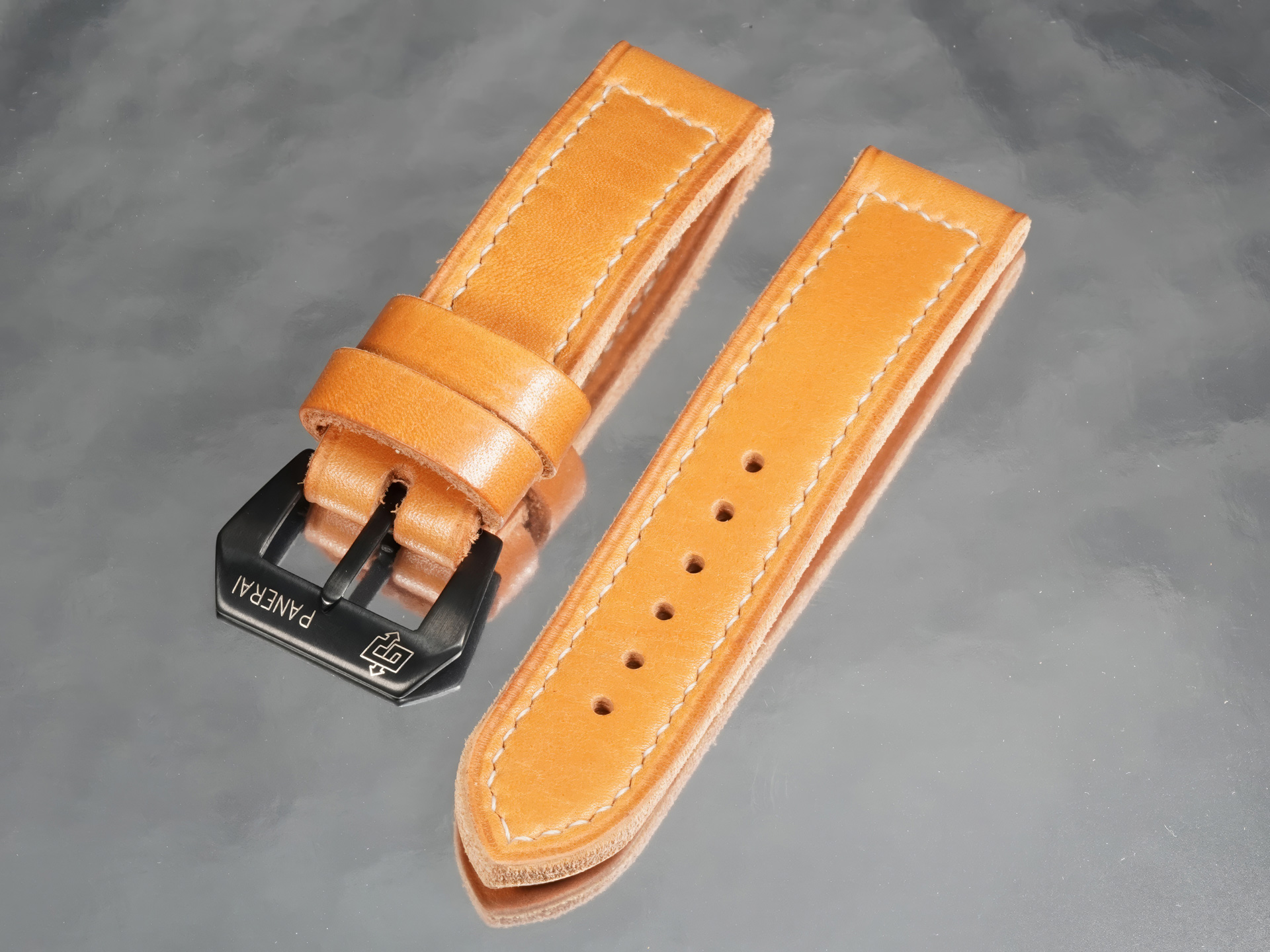 Side angle of 5mm thick orange tan leather Panerai strap with black buckle by Marcello Straps