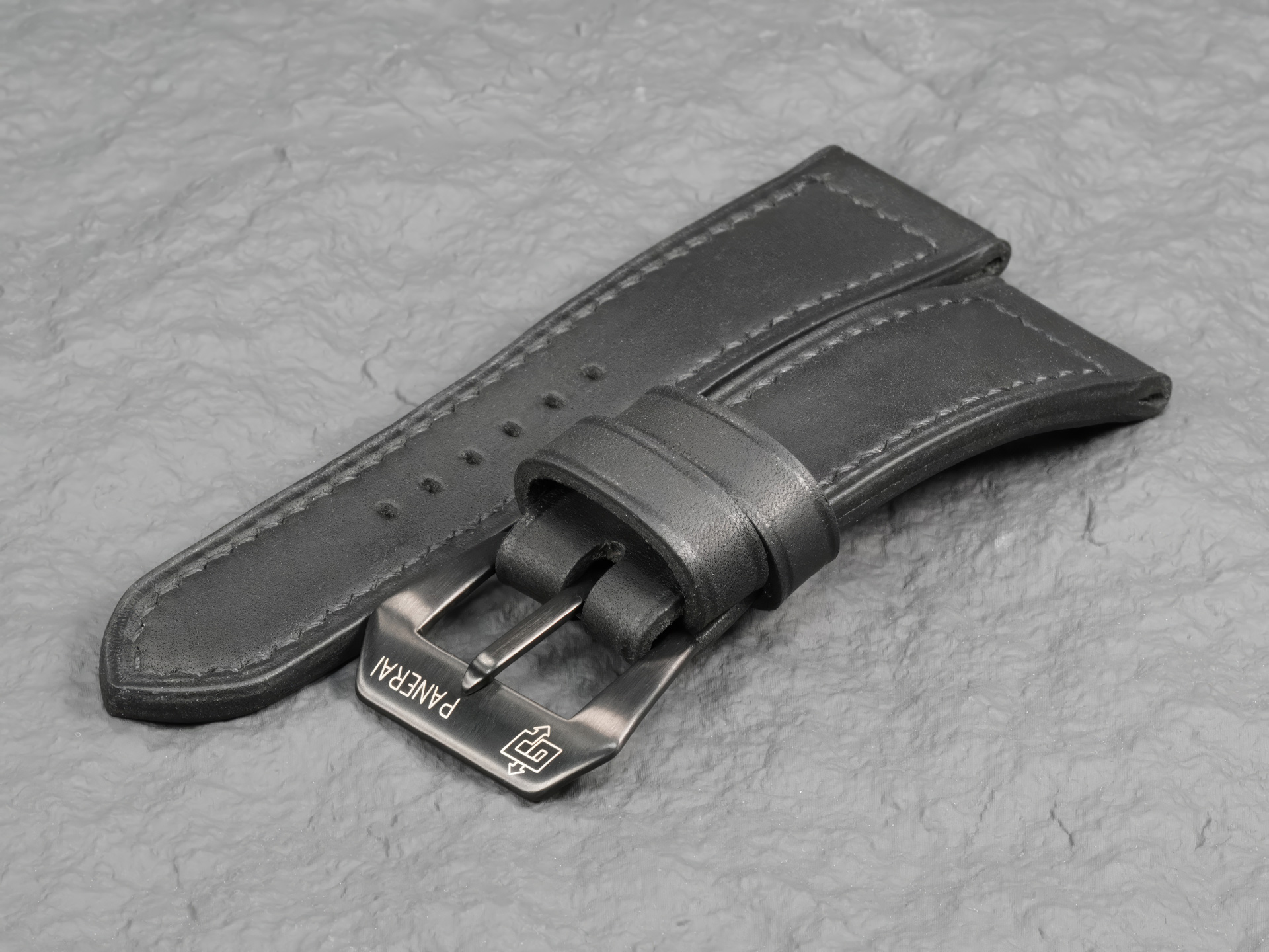26mm custom leather watch strap in matte black on Panerai Radiomir ceramic wire lugs.
