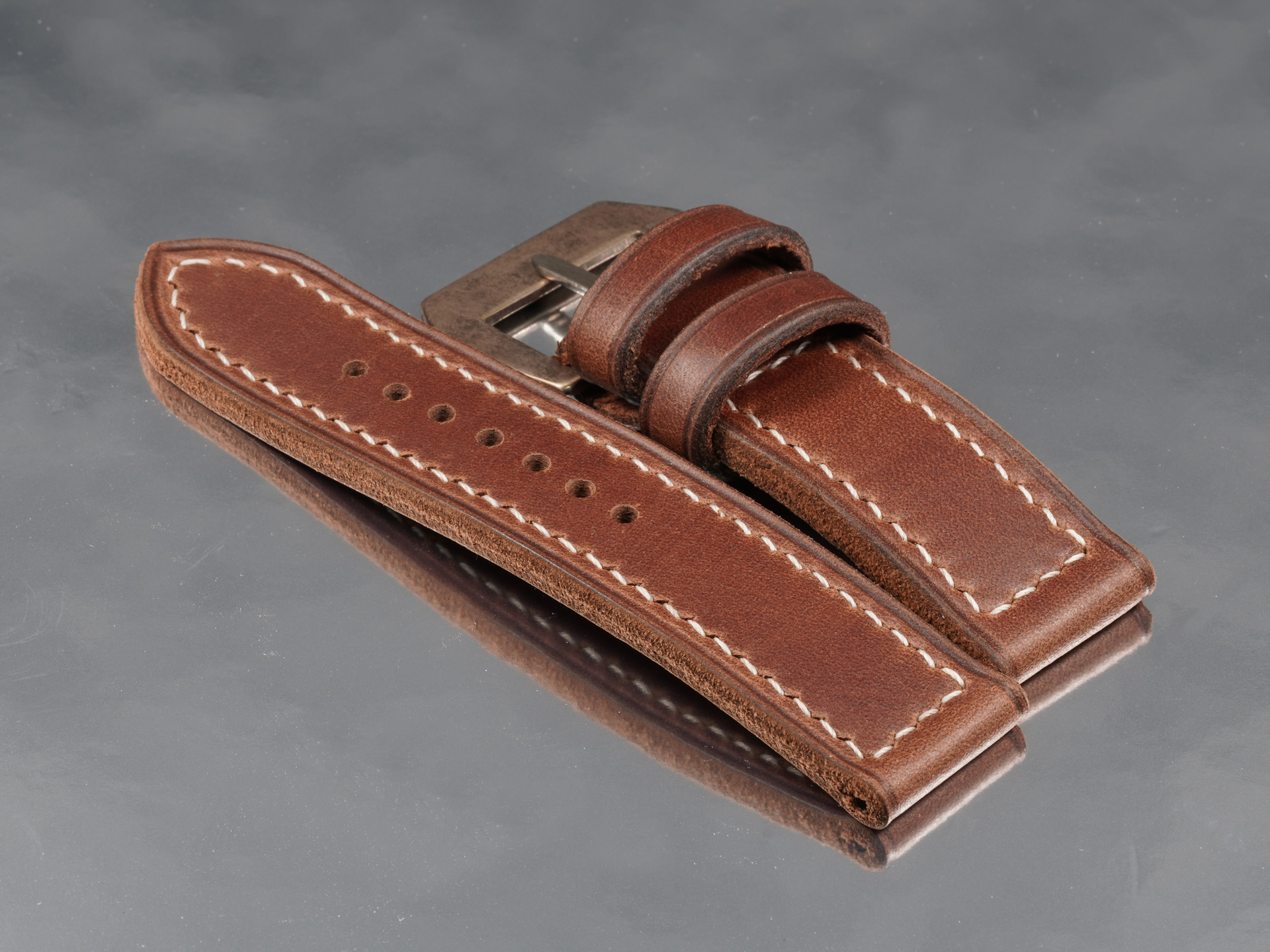 24mm wide handcrafted rust brown aged leather strap isolated on white